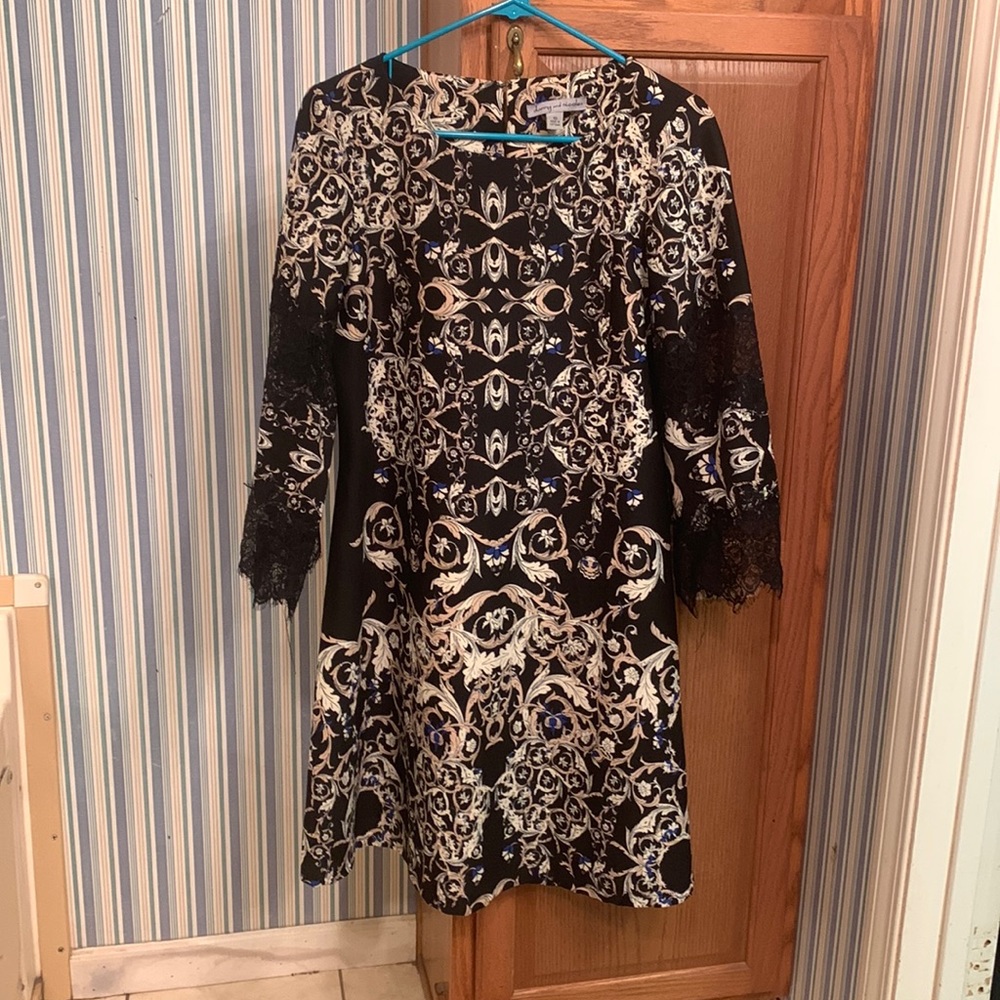 Long sleeve dress has lace on the arms and below the knee